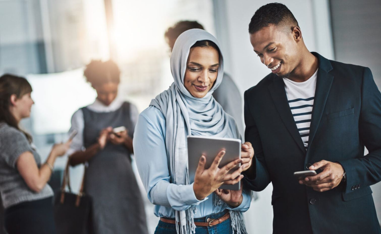 Man and woman looking at their connected checking and savings accounts on their ipad