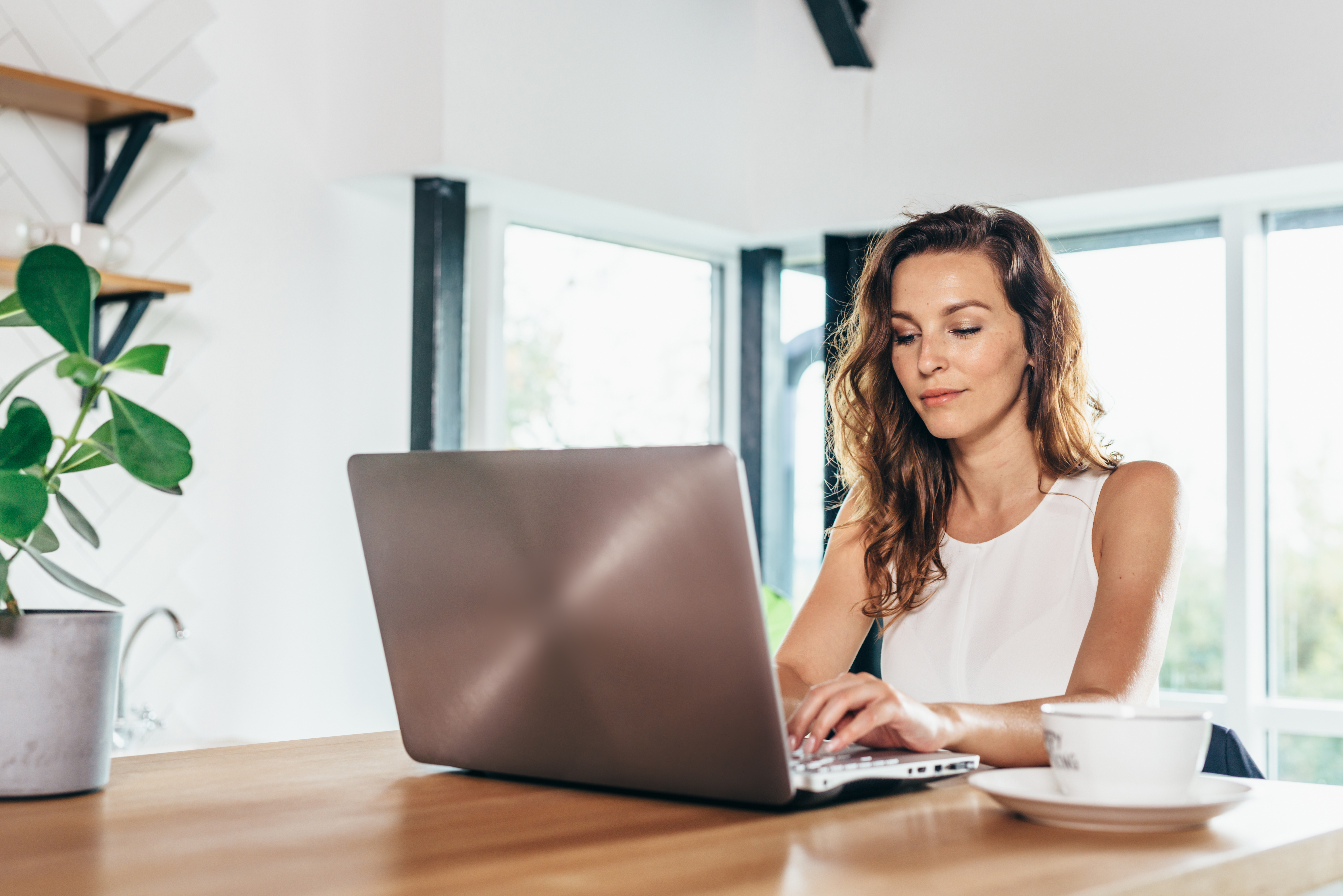 Woman banking from home knowing her savings are FDIC insured