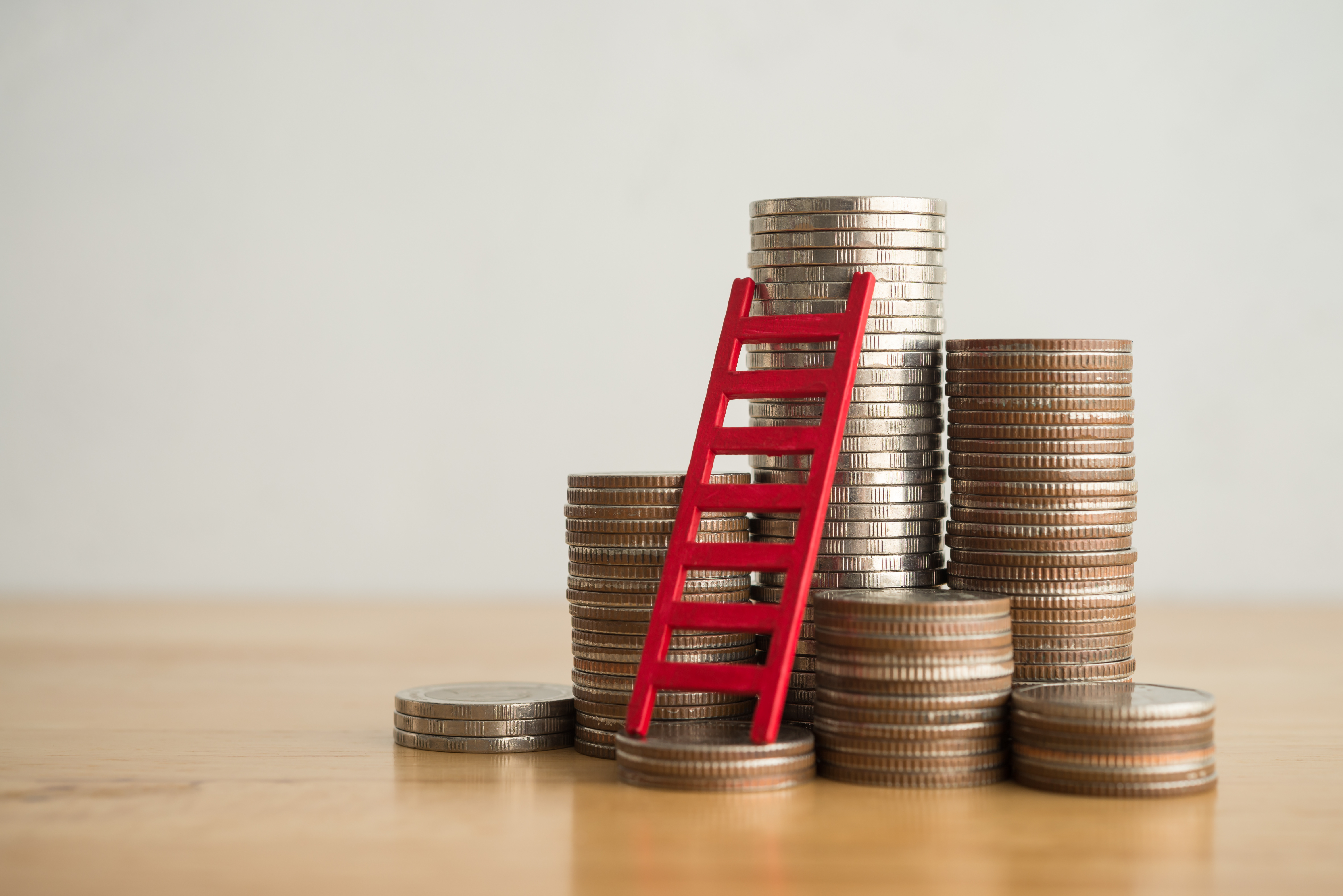 Stack of pennies earned from a CD Ladder with a ladder leaning against them