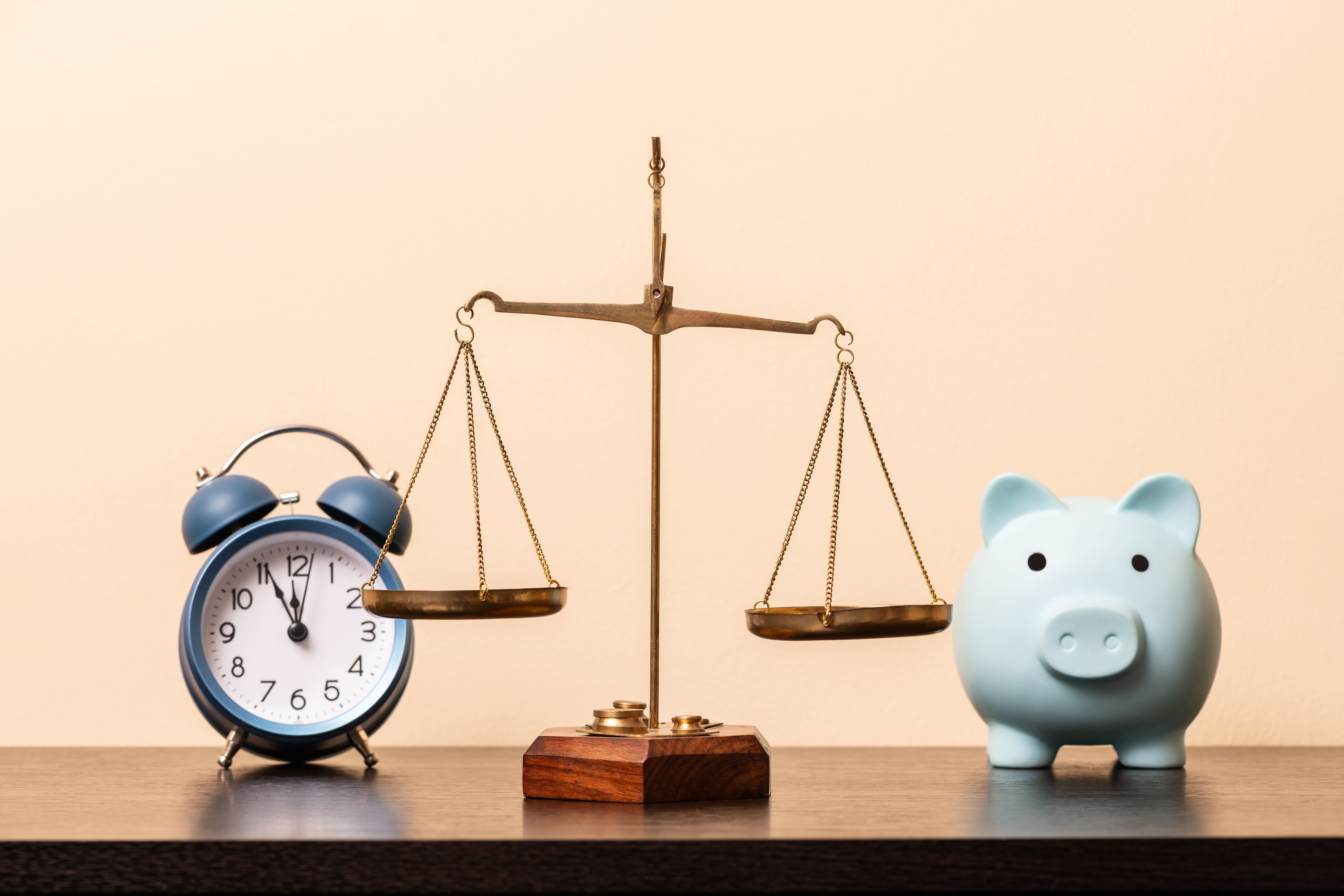 Scale between piggy bank and clock: representing the choice between CD Ladders and High Yield Savings