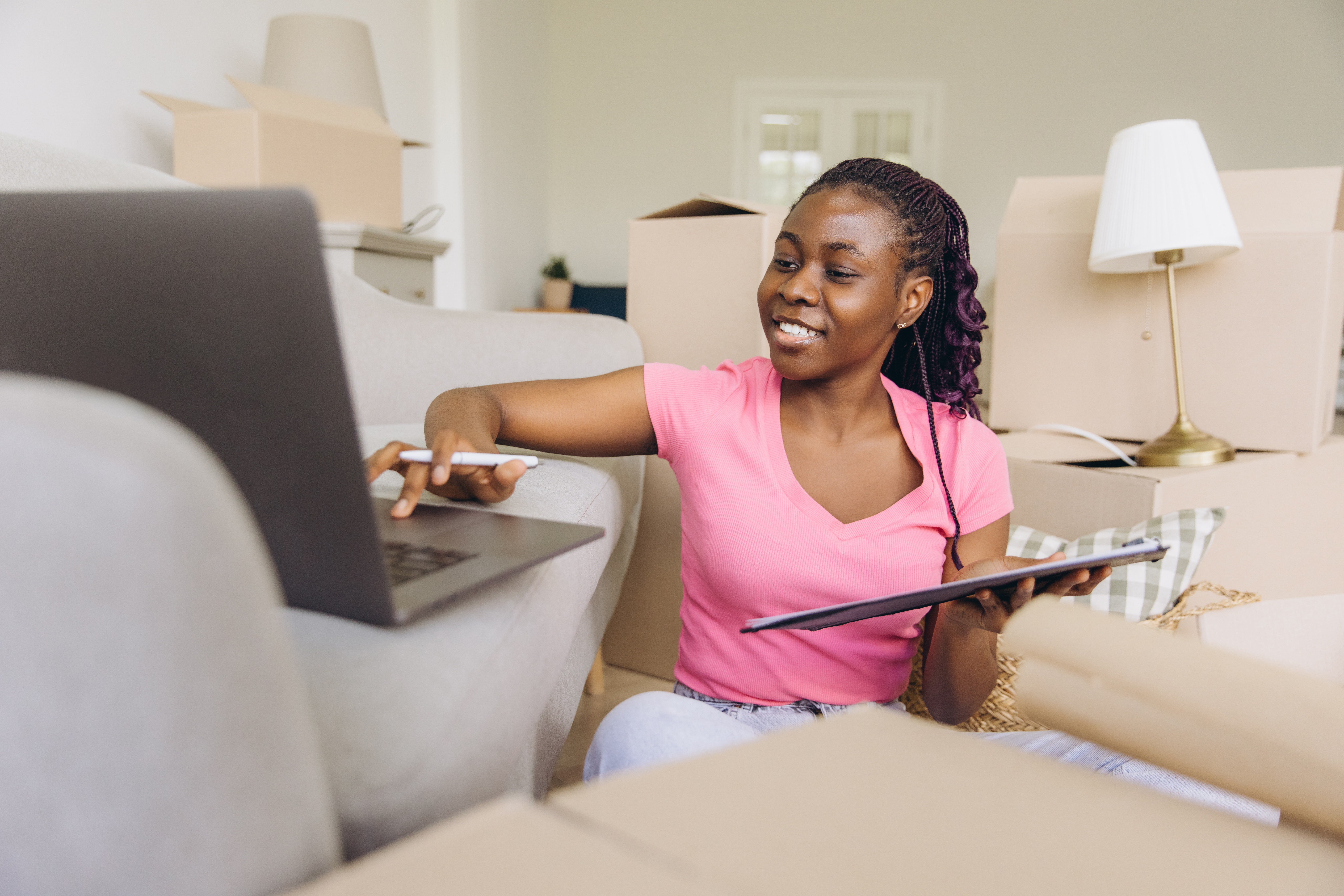 Woman at home on her laptop reviewing Leader Bank's FTHB checklist so she can become a homeowner
