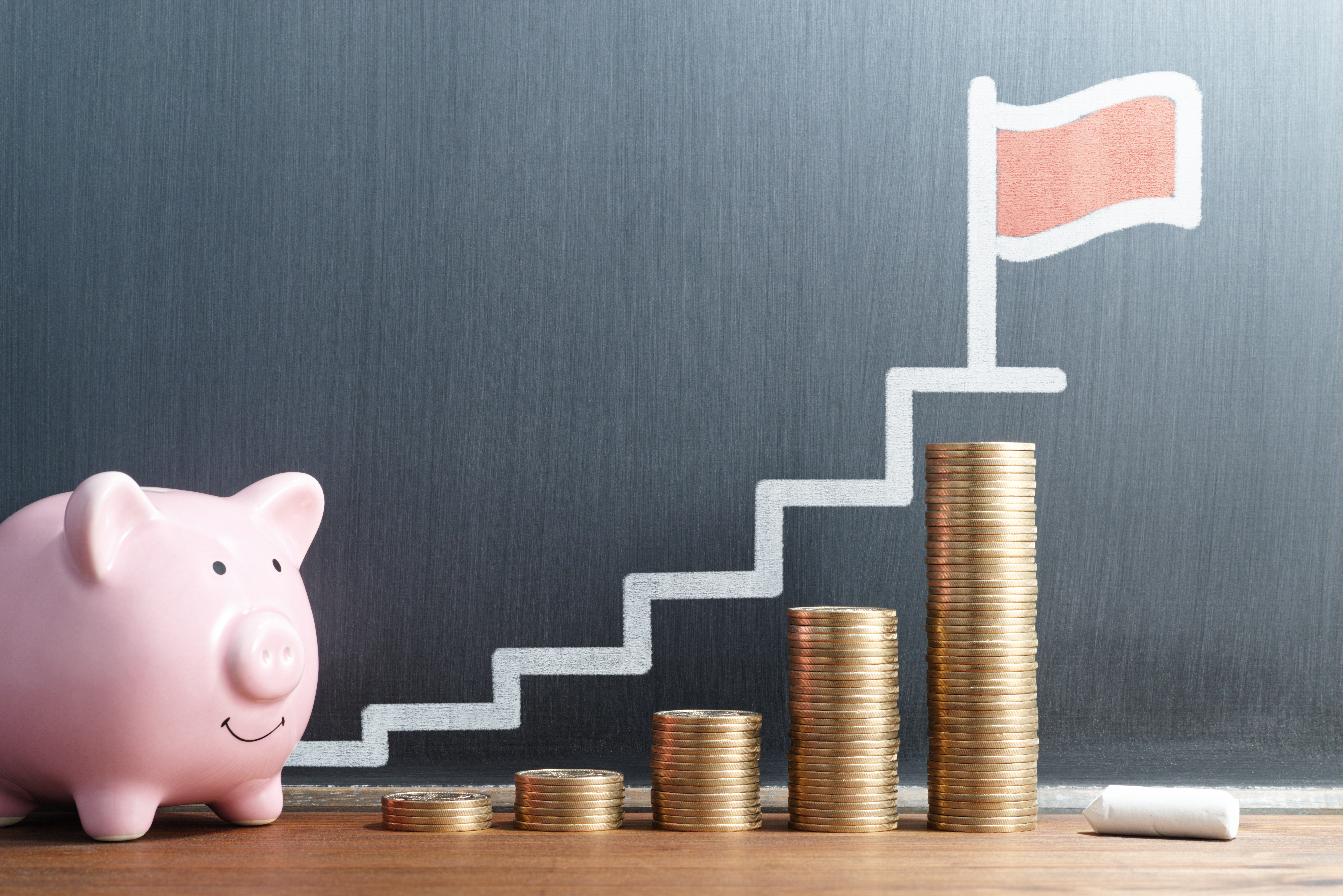 Piggy bank stacking coins over time by taking advantage of a CD Ladder during a rate changing environment