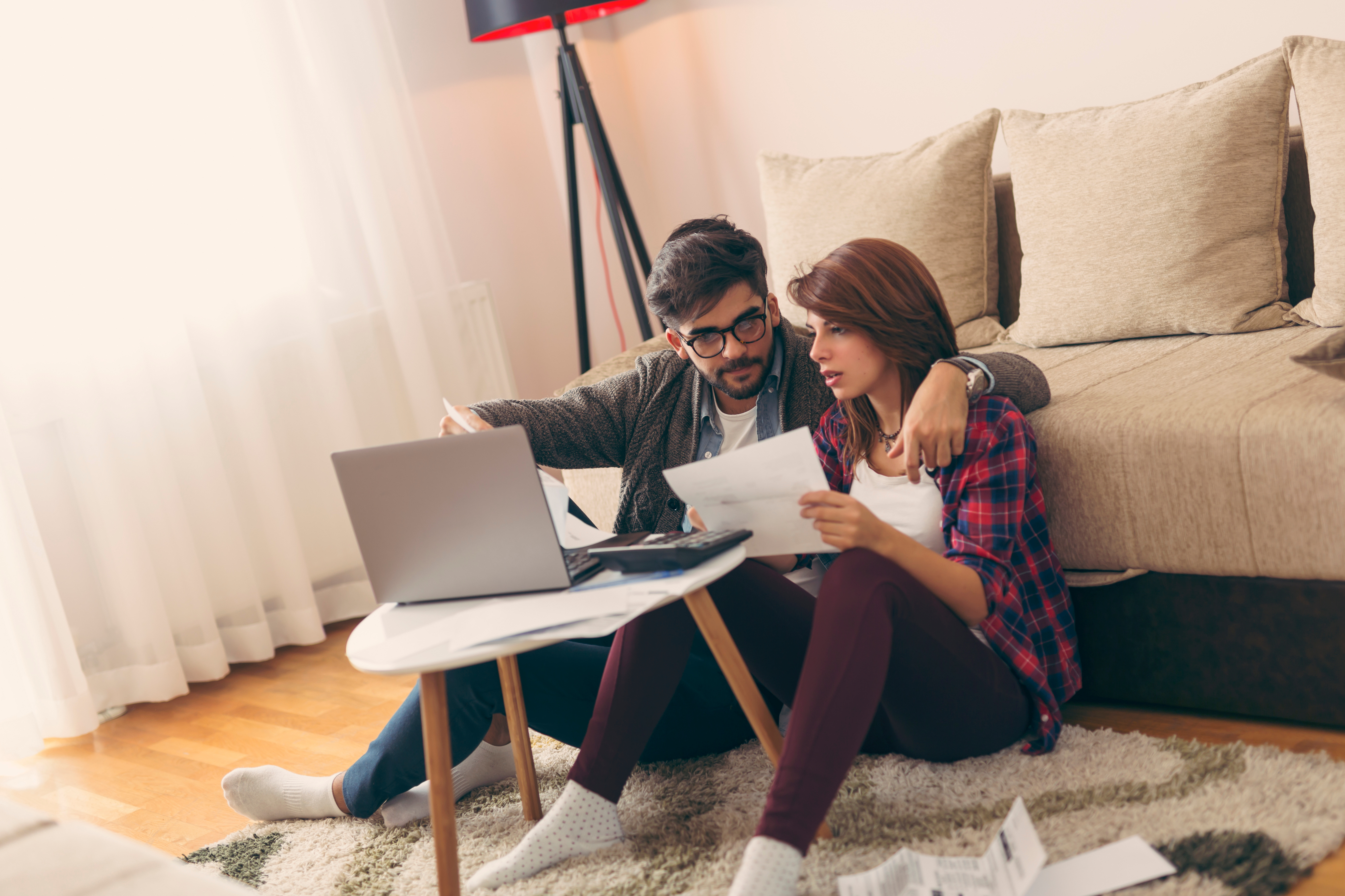 Couple exploring online their state and city down payment assistance options