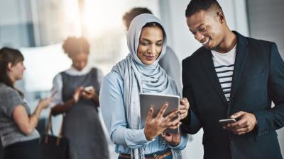 Man and woman looking at their connected checking and savings accounts on their ipad
