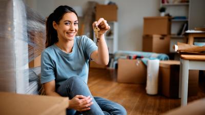 First time homebuyer unpacking her boxes with the keys to her new home