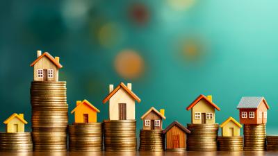 Picture of houses on coins some with lower mortgage interest rates than others