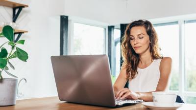 Woman banking from home knowing her savings are FDIC insured