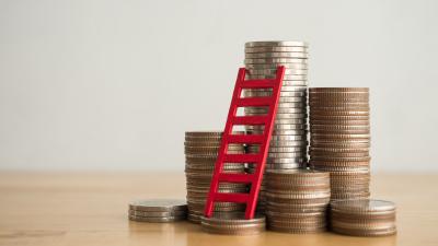 Stack of pennies earned from a CD Ladder with a ladder leaning against them