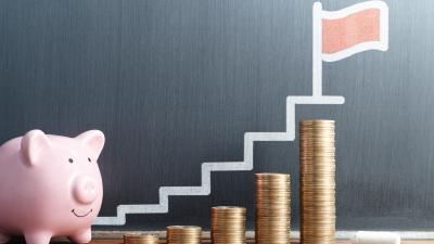 Piggy bank stacking coins over time by taking advantage of a CD Ladder during a rate changing environment