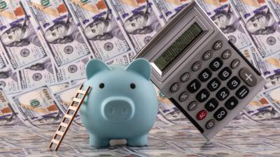Piggy Bank calculating how much money they need to start a CD Ladder