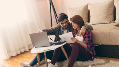Couple exploring online their state and city down payment assistance options
