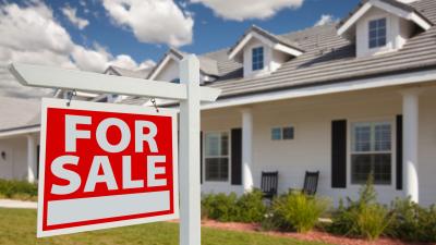 For Sale sign in front of a house - can you sell your home with a heloc?