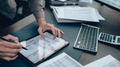 A small business owner analyzing their accounts and deciding between separate checking and savings accounts