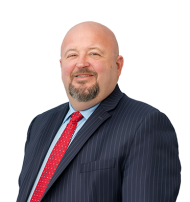 Leader Bank's Falmouth Branch Manager, Brendan Pike, smiling wearing a red tie.
