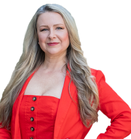 Chantelle Duquenoy Garrett smiles in a red blazer and dress.