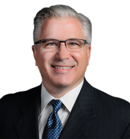 Leader Bank Loan Officer Thom Croy smiling at the camera while wearing a suit.
