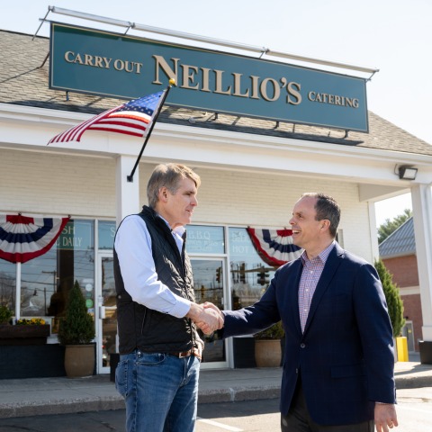 Neillio's Gourmet Kitchen and Catering owner Kevin O'Neill shakes hands with Leader Bank's Senior Vice President and Chief Lending Officer Matt Pierce shake hands outside of Neillio's Lexington storefront.